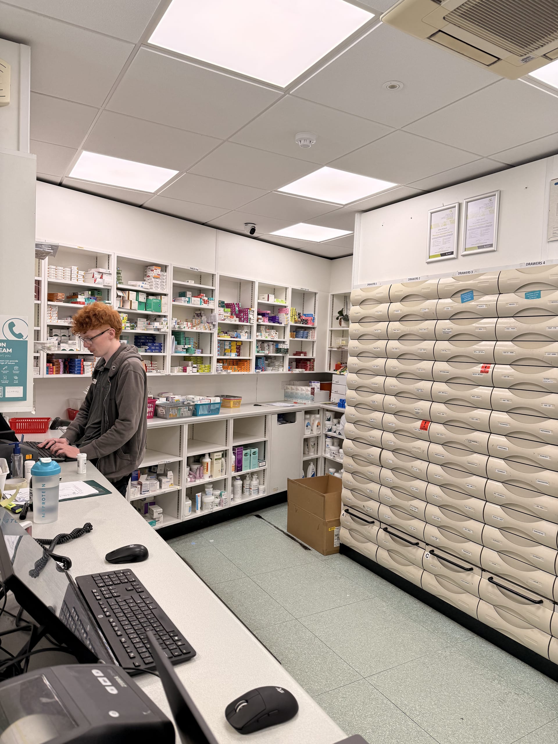 A member of the Medicine Stop team working at the automated dispensary.